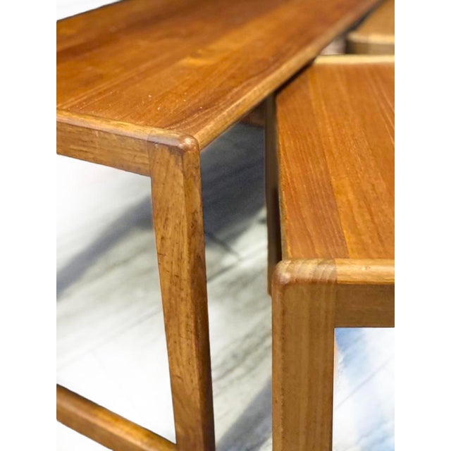 A practical and elegant set of nesting side tables in solid teak, dating from the early 1970s. The warm, close-grained...