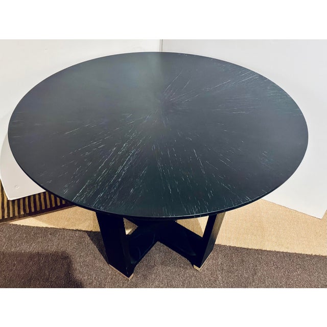 Original retail $3490, stylish Currey & Company Modern Black Cerused Oak Finished Blake Dining Table, brass capped base,...