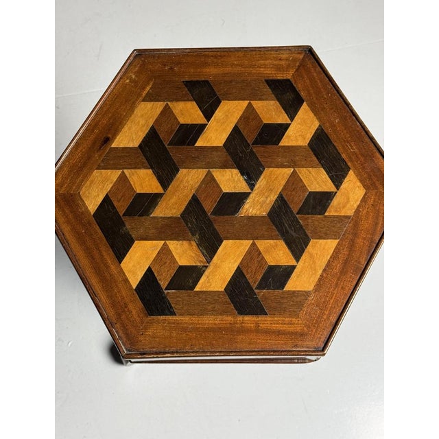 French Marquetry side table with drawer. Mahogany veneered and the top is inlaid with various types of wood. Signs of use...