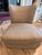 This elegant slipper chair has a textured tan fabric upholstery with a subtle crackle pattern. This piece is designed by...