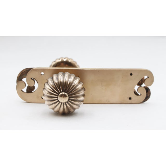 Vintage passage fluted door knob set with curled ends on the back plate and a polished finish. Good condition with...