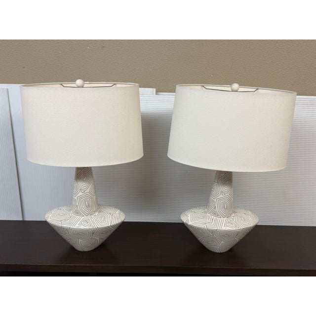 Design Plus Gallery presents a Pair of Toronto Table Lamps from Arteriors. Each lamp has an ivory-glazed ceramic body...