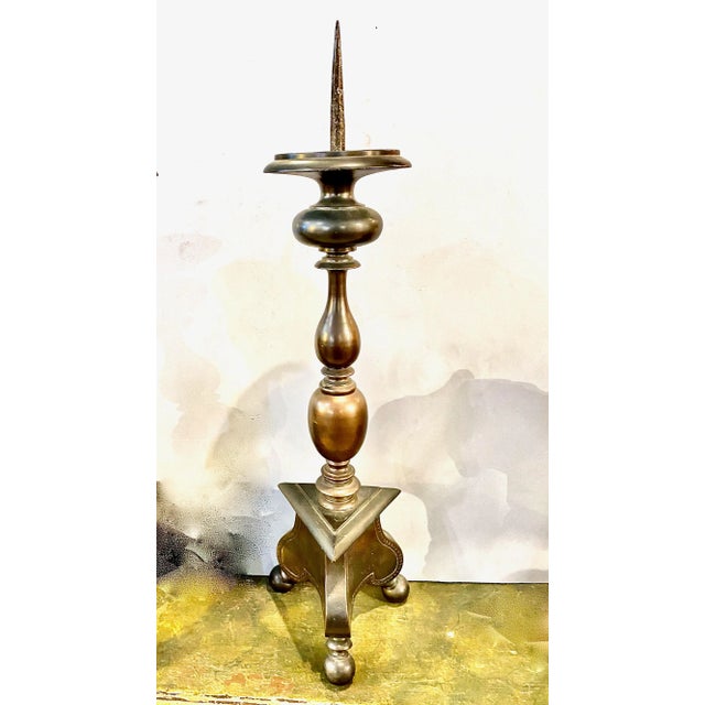 This is a good example of early 18th century Italian solid bronze pricket candlesticks. The tripartite base is supported...