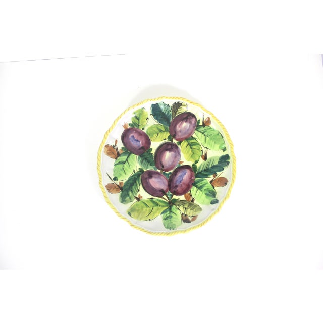 Vintage hand painted plum fruit large ceramic plate with a scalloped edge and yellow rope detail. This is in very good...