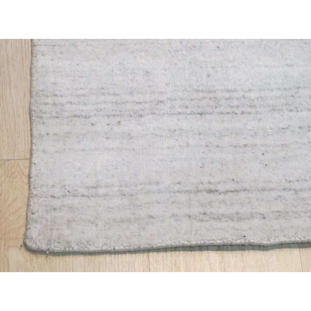 Xena Maya Ivory Handmade Wool & Viscose Rug, Country of Origin: India. This luxurious piece embodies the modern evolution...