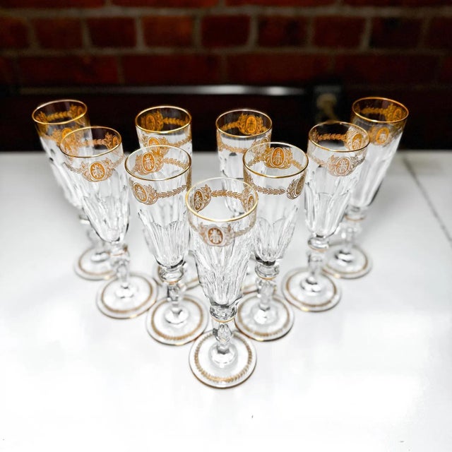 • Rare and highly collectible set of 10 Saint Louis crystal champagne flutes • Features the iconic Napoleonic bee and...