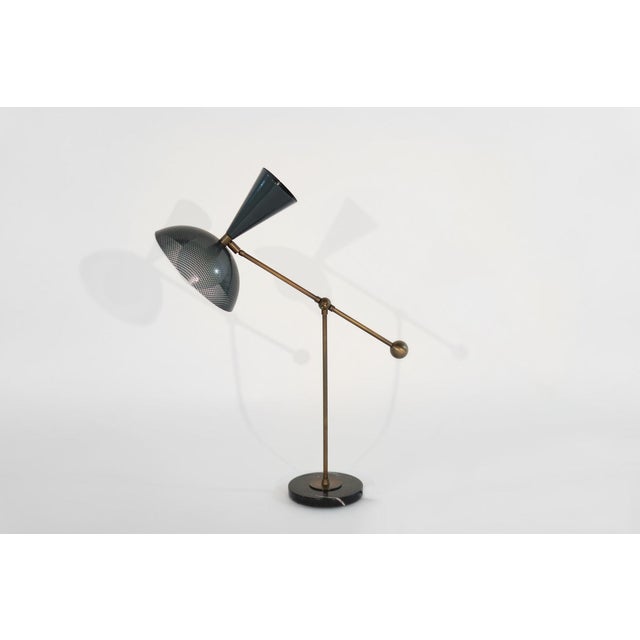 The Molto table lamp or desk lamp is a fresh, new take on Italian modernism, featuring a spun-metal mesh shade, brass...