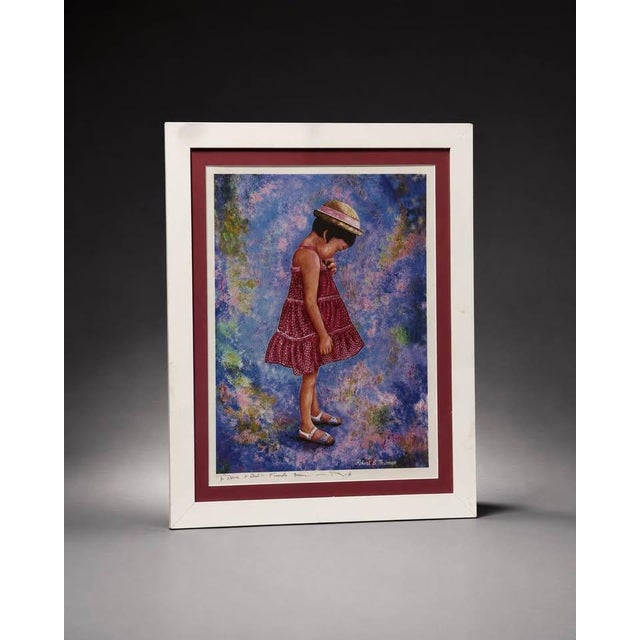 Decorative framed portrait print featuring a young girl in a red dress and hat against a colorful blue, purple, and...