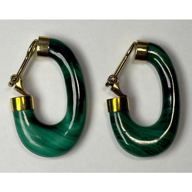 This is a beautiful pair of 14K yellow gold lever-back clip earrings with malachite elongated hoops.