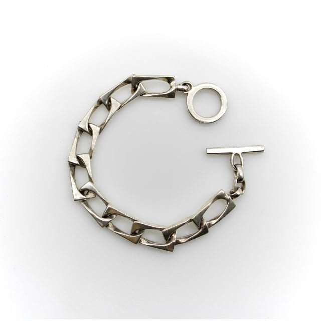 This unusual take on a curb link bracelet is made by Gucci circa the 1980’s. The curb link is both elongated and squared...