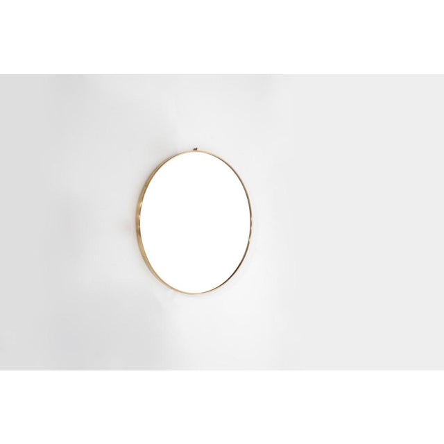 Vintage round brass mirror, some screws missing and new glass. Italy, 1960s. Production period: 1960s. Dimensions: 61 cm...