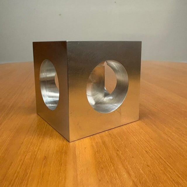 A captivating fusion of industrial technique and sculptural minimalism, this 3-inch solid aluminum cube (signed and...