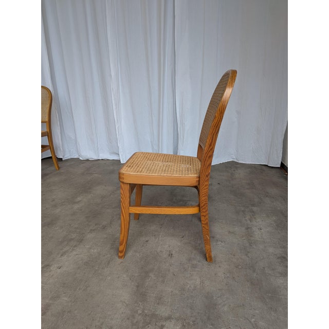 Vintage wooden rare dining chairs with cane seat and cane backrest. Chairs are designed in mid-century style. They were...
