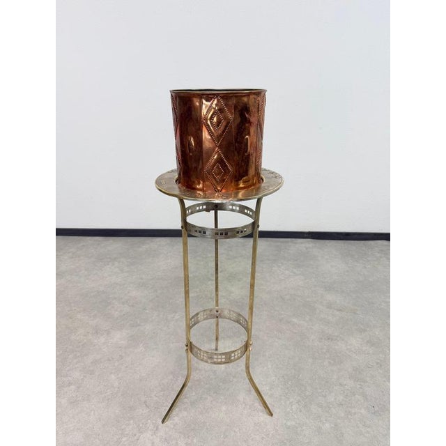 A rare and highly sophisticated antique Art Nouveau plant stand (pedestal), masterfully crafted from solid brass in the...