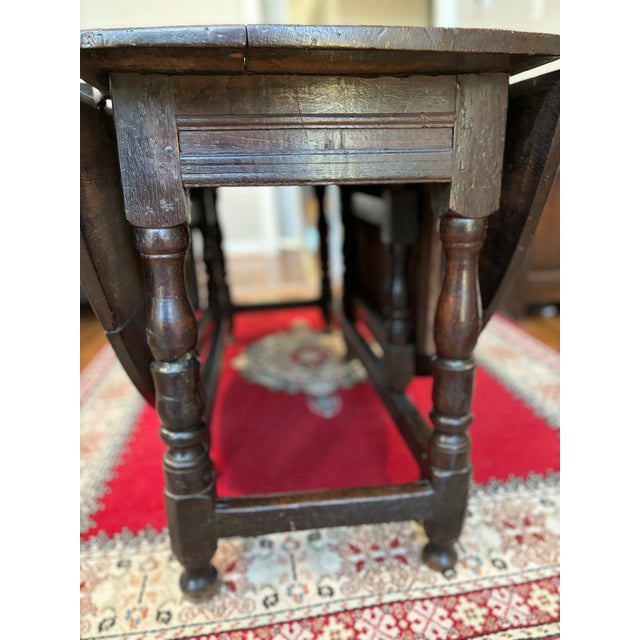 This beautiful traditional gate-leg table, crafted in rich, aged oak with an old, warm patina dates from roughly 1670, a...