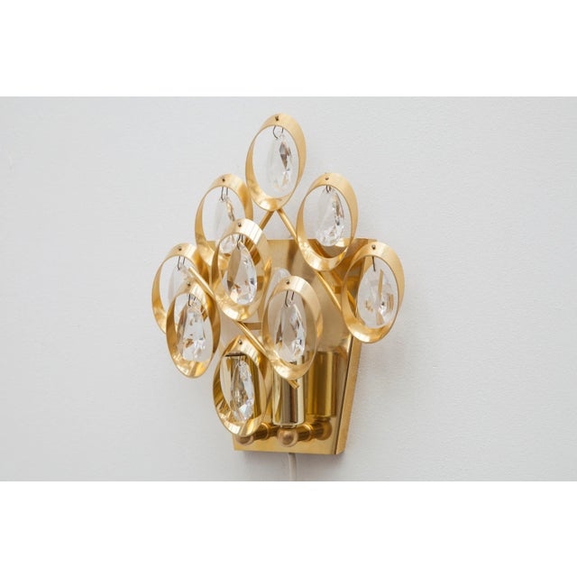 Set of two 1960s wall lights by palme and walter, germany. Features eight glass crystal teardrops on a frame made of...