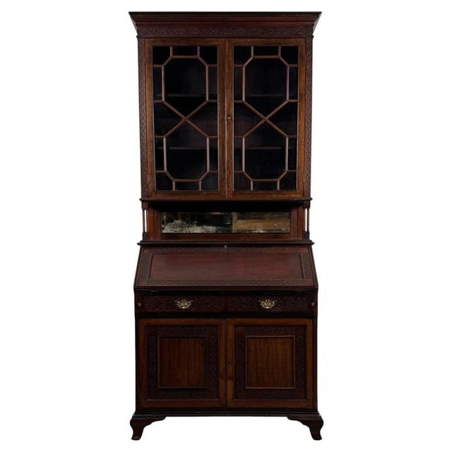 An impressive early 20th-century English bureau bookcase in the Chippendale Revival style, finely crafted from mahogany...