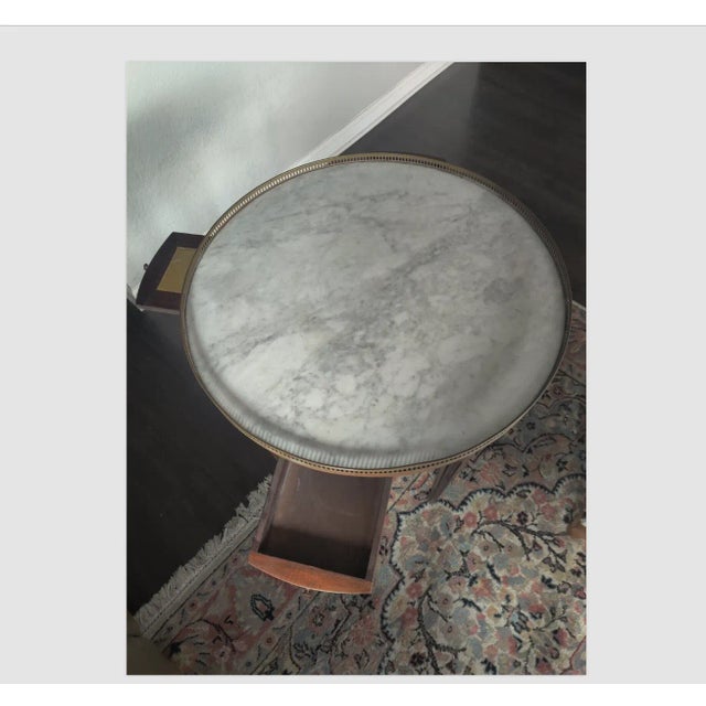 A unique 19th century Louis XVI Style mahogany round side table Bouillotte. Marble top, golden rail, two drawers and...