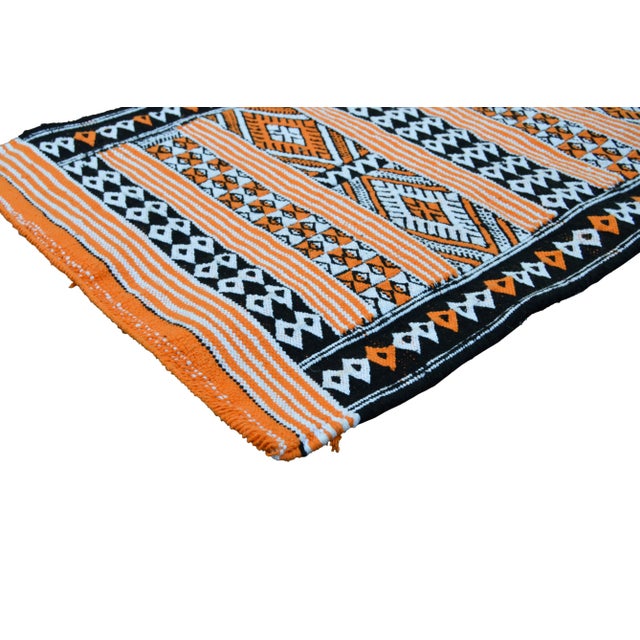 Handwoven Moroccan Berber Kilim with a design of diamonds and geometric shapes.