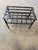 Substantial handmade wrought-iron fireplace trivet or kettle stand featuring traditional hand-worked construction and an...