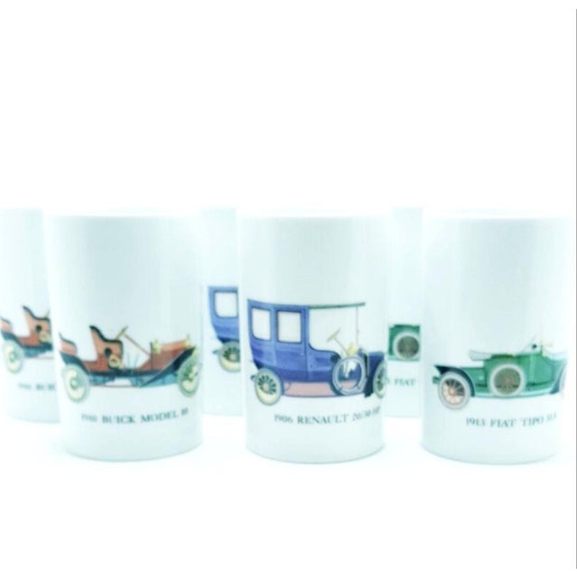 Made by Thomas of West Germany, the set has a tall, long neck jug and 12 drinking cups. 7 different car models are...