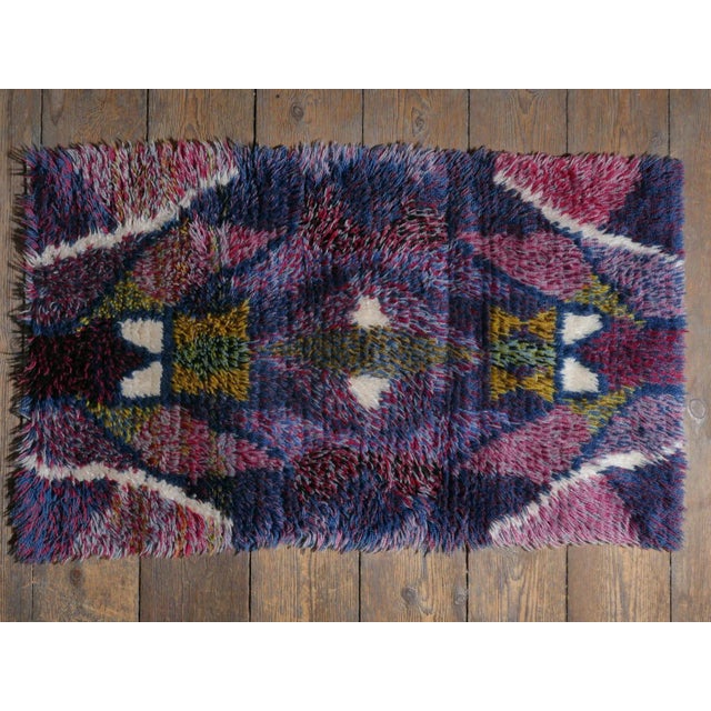 This is a very rare Scandinavian Modern high-pile wool rya rug has soft, vivid tones of pink, purple, yellow, blue, red,...