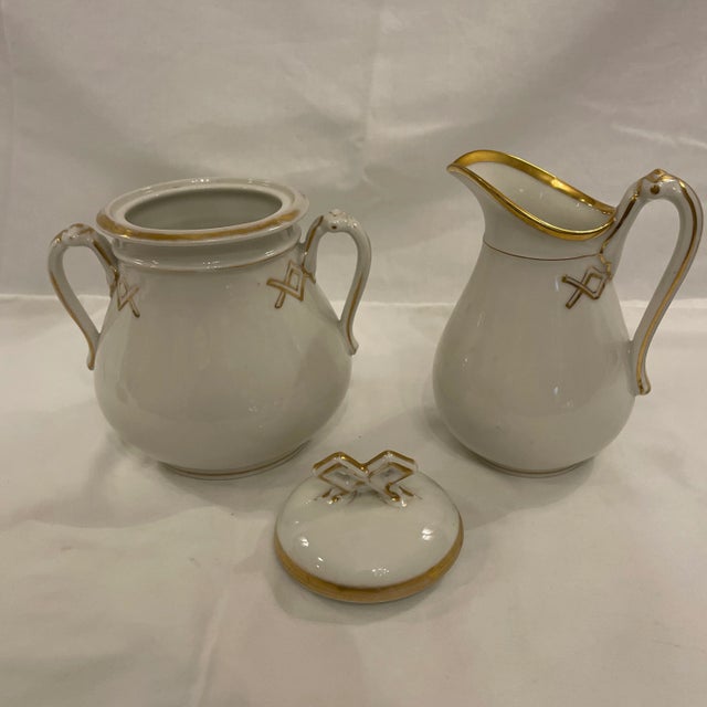 Perfect addition for your tea or coffee set. A fines Limoges old Paris porcelain white bodied sucrier with lid and ewer...