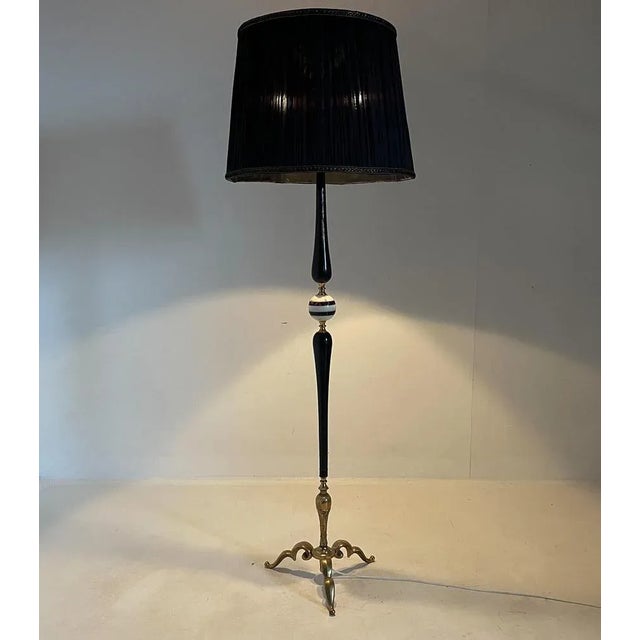 Stunning vintage floor lamp made of ebonized wood, onyx and brass with black fabric lamp shade. Produced in Italy in the...