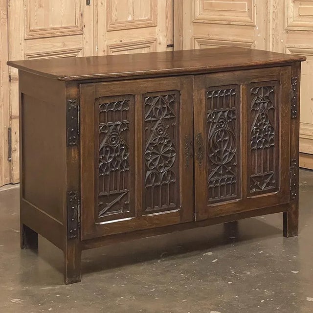 19th Century French Gothic Credenza is a remarkable work of the cabinet maker's art, featuring tailored architecture...