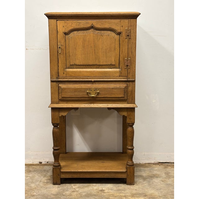 A wonderfully practical 19th century English oak cabinet, thoughtfully designed and beautifully proportioned for everyday...