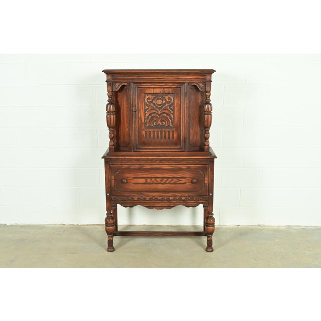 An exceptional antique English Jacobean, Tudor, Victorian, or Renaissance Revival style bar cabinet In the manner of...