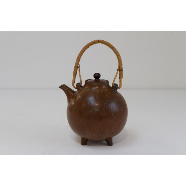 Scandinavian Mid-Century Modern teapot in glazed stoneware with braided bamboo handle. Designed by Gunnar Nylund, made by...