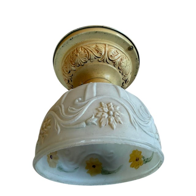 This charming fixture features a white embossed glass dome shade with a raised floral motif. The glass also has hand-...