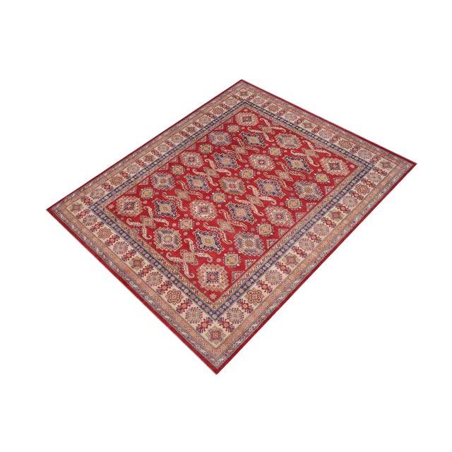 Enhance your home with this exquisite hand-knotted Kazak rug, crafted from fine hand-spun wool and dyed with all-natural...