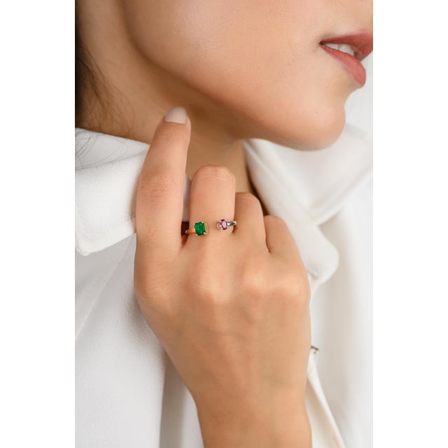 This exquisite 18k two-tone ring features a stunning square-cut emerald paired with an oval ruby in a unique "Toi et Moi"...