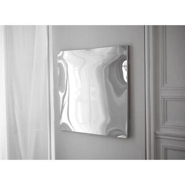 Distorting square wall mirror in polished stainless steel by julien vidame. Dimensions: w 94 x d 3 x h 94 cm. Materials:...