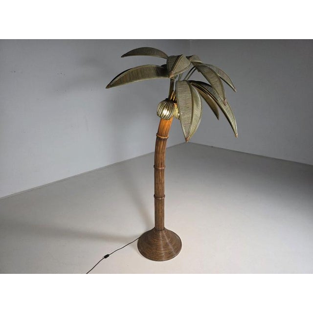 A striking Mexican palm tree floor lamp from the 1970s, crafted from bamboo and rattan. Designed by Mario Lopez Torres....