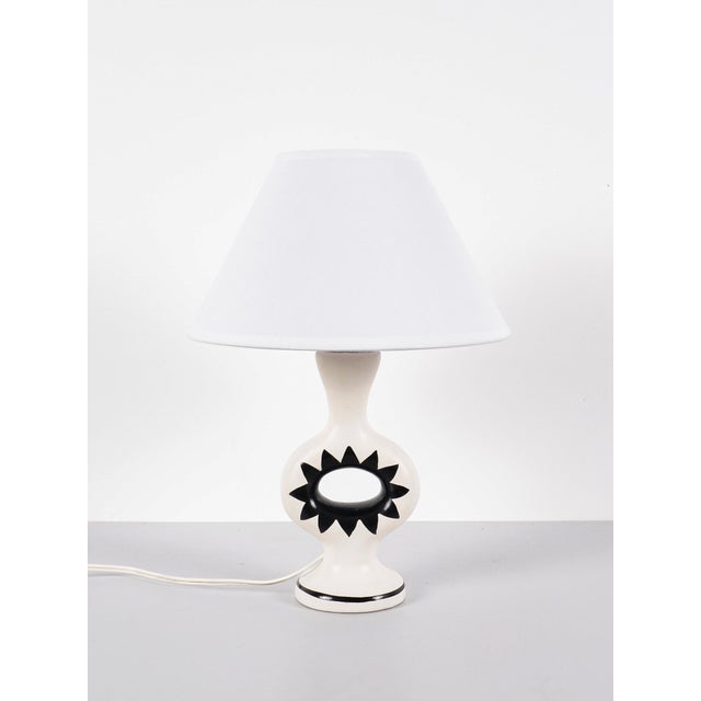 Lamp france, circa 1950 ceramic h: 21 cm / w: 11 cm / d: 9 cm total h: 34.5 cm excellent overall condition. Some signs of...