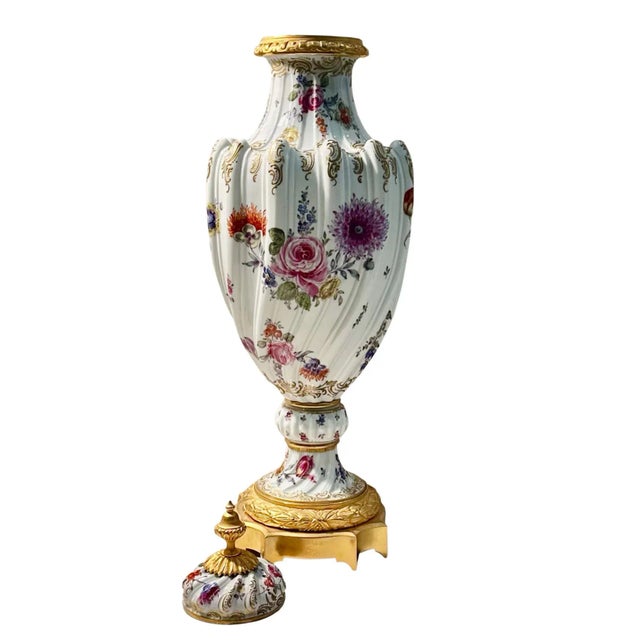A single Sevres style porcelain garniture decorated with hand painted flowers. Fitted with bronze ormolu which has been...