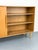 Exceptional oak highboard with a variable sliding door that conceals either the right or left shelf section. A clever...