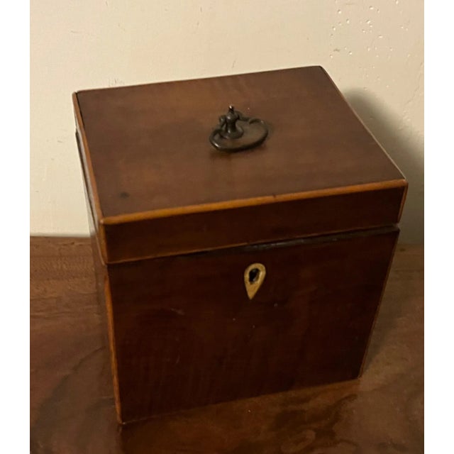 Small scale antique 18th century Georgian mahogany tea caddy with divided interior and original brass loop at the top....