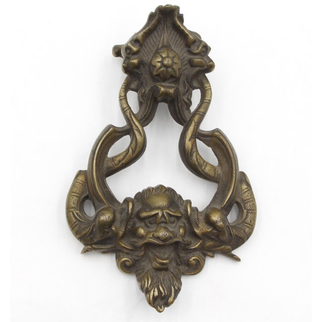 Vintage bronze door knocker with strike plate featuring the mythical god of the sea, Poseidon, with a prominent face and...