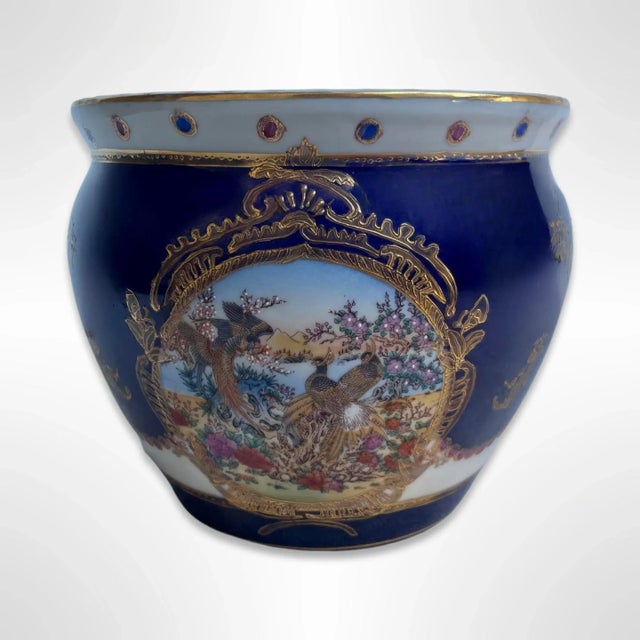 A stunning vintage porcelain ceramic fish bowl /vase. The exterior is cobalt blue and decorated with elegant gold gilt and...