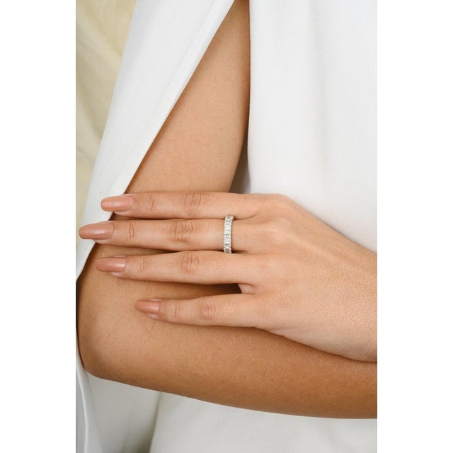 This is part of Chairish’s Fine Jewelry assortment. A baguette diamond eternity wedding band features sleek, rectangular...