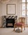 Striking vintage solid oak occasional chair featuring a sculptural frame, gracefully curved arms, intricately carved ball...