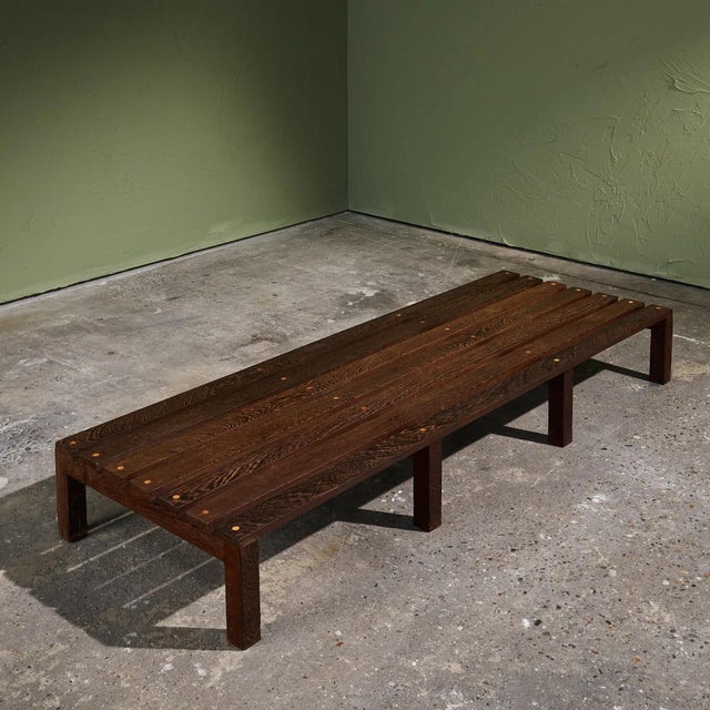 This bench is made of solid Wengé wood and features a surface composed of evenly spaced wooden slats. The bench stands on...