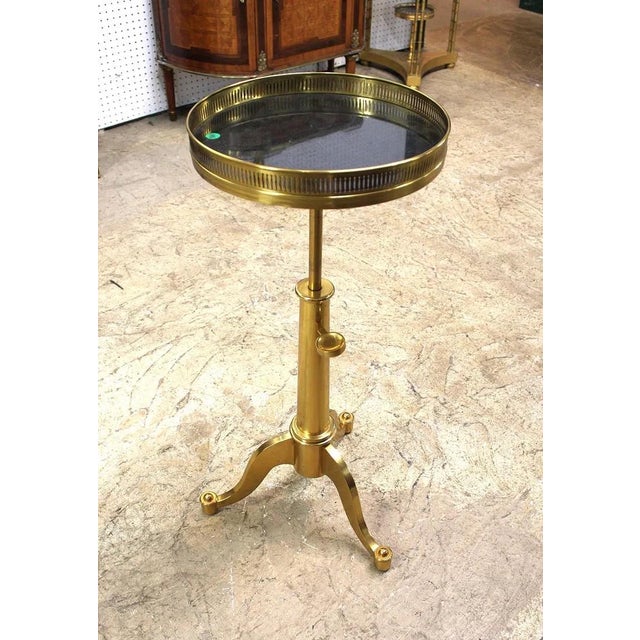 Maison Toulouse style solid brass telescoping side table with black marble in the French Style on tripod base....