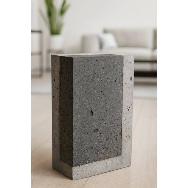 A minimalist sculptural block where raw industrial material meets quiet refinement. The piece juxtaposes two tonalities of...