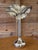 A striking vintage sculptural candlestick or bud vase featuring an elegant flower-form top with softly hammered petal...