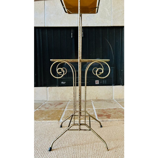 A wonderful 1950s brass side table that features a colorful enameled or glass adorned metal tray. A supreme accent for...
